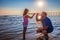 Dad and daughter give each other five by the sea