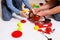 Dad and daughter play with sliced plastic vegetables and fruits with Velcro, cooks food on a toy stove in a bowl. Children`s