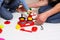 Dad and daughter play with sliced plastic vegetables and fruits with Velcro, cooks food on a toy stove in a bowl. Children`s