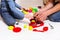 Dad and daughter play with sliced plastic vegetables and fruits with Velcro, cooks food on a toy stove in a bowl. Children`s