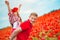 Dad and daughter in a poppy field