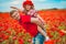 Dad and daughter in a poppy field