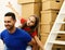 Dad and daughter pretend to fly by pile of boxes