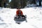 A Dad and Daughter Race Down a Snowy Hill