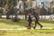 Dad and daughter roller-skate in the park. Leisure weekend together