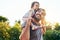 Dad, daughter and smile on shoulders in park with trust, happiness or love in summer sunshine. Young family, baby girl