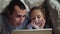 dad and daughter under the blanket with a digital tablet. kid dream online night video games at concept. dad and