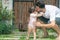 Dad and daughter walking, father helps child to make baby steps, barefooted outdoor. Baby needs father hold