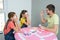 Dad and daughters play board games at home