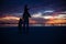 Dad and daughters silhouette in the sunset on the