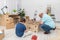 Dad fits the shelves together and son waits with the screwdriver.