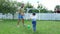Dad with a four-year-old son playing ball, football, in the yard on a green lawn, in the summer.