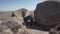 Dad gives his son a piggyback ride between huge rocks in the beautiful nature of Eswatini