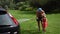 Dad and happy little girl washing car outdoor. Man with daughter have fun