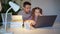 Dad helps daughter with online lessons on laptop. Distance education.