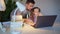 dad helps daughter with online lessons on the laptop, distance learning. 