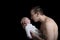 Dad holding newborn baby on black background. Fathers love concept. Side view, isolated