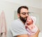 Dad holds his daughter in his arms after the first bath