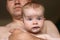 Dad holds  little girl in his arms, safety in  hands of parents, drooling from  childï¿½s mouth