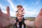 Dad keeps his daughter sitting on his shoulders. cheerful father and daughter take selfies at arm`s length camera. look through