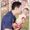 Dad kiss male baby at home