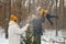 Dad lifting his happy little son up in the air during family stroll in forest