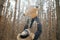 Dad lifting his happy little son up in the air during family stroll in forest