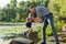 Dad lifts his little son in his arms at the river background