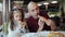 Dad with a little daughter enjoying the taste of fragrant pizza in a pizzeria