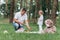 Dad and little daughter on picnic in the park on summer day. Young father cuts watermelon. father`s, baby`s day. happy holiday