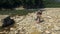 Dad with a little daughter is walking near a mountain river. Traveling with children