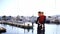 Dad with a little girl in his arms stands on the pier and shows her the sea