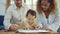 Dad, Mom and little daughter drawing with colorful pencils on paper happy smiling.Young family spend free time together in living