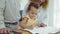 Dad, Mom and little daughter drawing with colorful pencils on paper happy smiling.Young family spend free time together in living