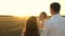 Dad and mom playing with a little daughter in her arms at sunset. family walks with a child at sunset. father playing