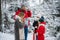 Dad and mom went out with the children to enjoy the winter nature in a snow-covered forest with firs and pines