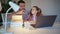 Dad plays and helps daughter lessons on laptop