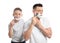 Dad shaving and son imitating him on white