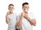 Dad shaving and son imitating him on white