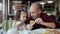 Dad with a small daughter eat pizza at a pizzeria. Unhealthy food, Eating fast food