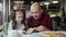 Dad with a small daughter in a pizzeria eating pizza