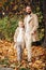 Dad and son in autumn, stylishly dressed, walking in the park