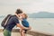 Dad and son in the background of Tropical beach landscape panorama. Beautiful turquoise ocean waives with boats and sandy coastlin