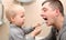 Dad and son brush their teeth in the bathroom. Father Brushing Teeth to Child