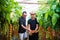 Dad and son check harvest of cherry tomato in greenhouse family business