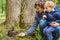 Dad and son feed a squirrel in the park