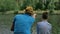 Dad and son on the fishing on coast of river