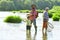 Dad and son fishing at lake. Father and son fishing. Generations men. Boy with father and grandfather fly fishing