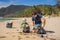 Dad and son in gloves cleaning up the beach pick up plastic bags that pollute sea. Natural education of children