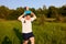 Dad and son having fun in nature in summer, father holding his child on his shoulders with pinwheel